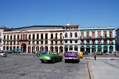 51 Cuba - Havana Centro - Old American Cars and colourful buildings across from Capitolio.JPG